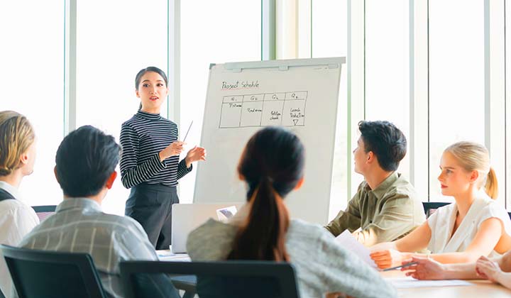 young asian Business woman leader conducting company sales business strategy presentation in the meeting room modern office background